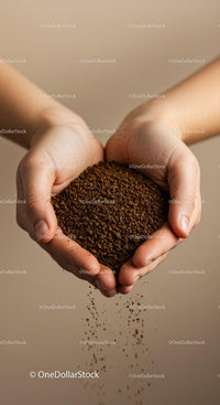 Hands gently holding and pouring instant coffee granules