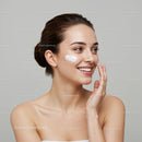 Young Woman Applying Face Moisturizer for Radiant Skin