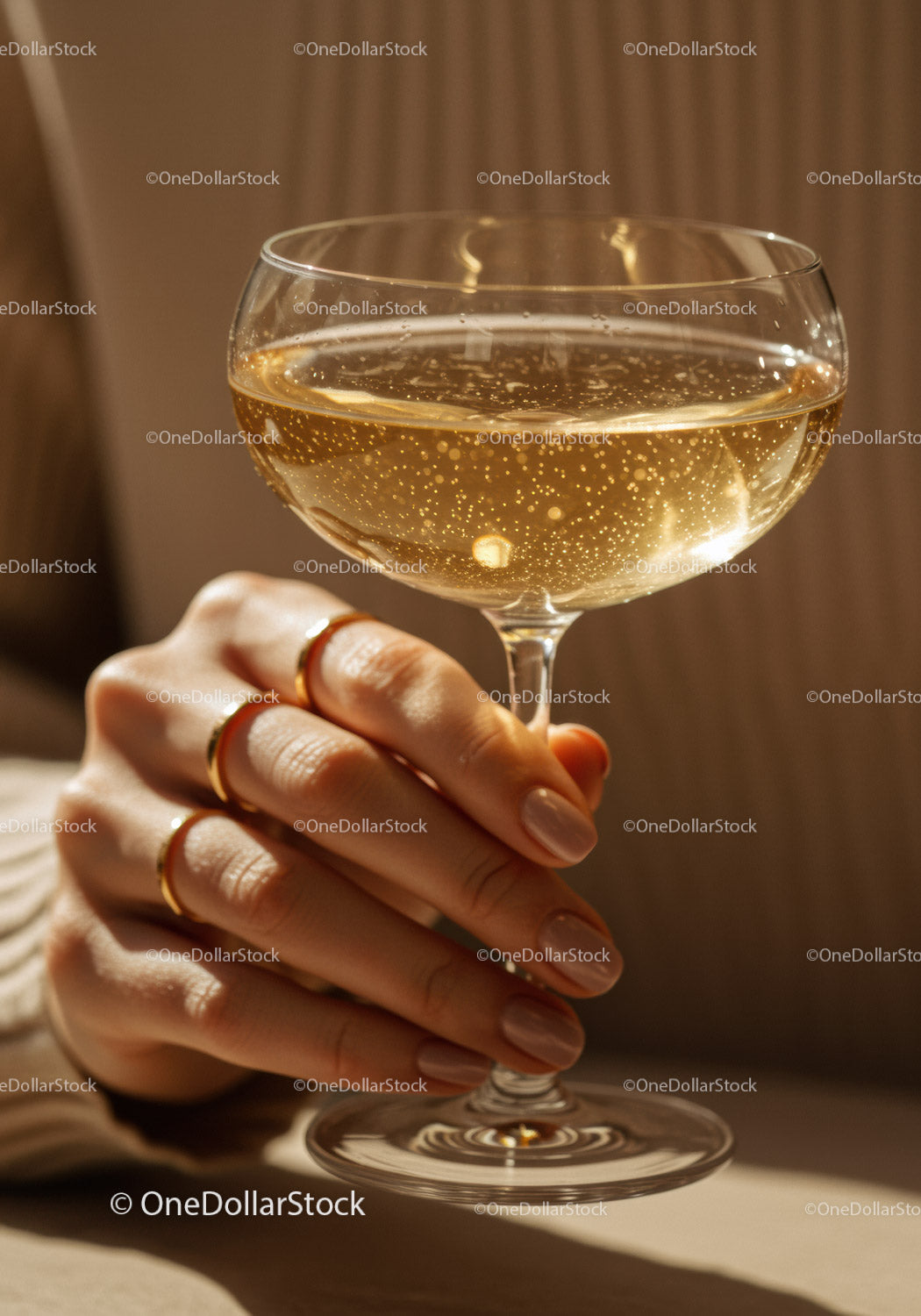 Close-up of hand holding sparkling champagne glass