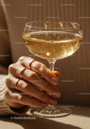 Close-up of hand holding sparkling champagne glass