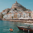 Scenic Coastal Harbor with Boats and Hillside Town under Blue Sky