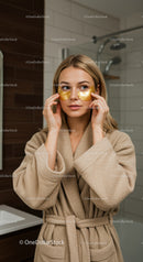 Woman Relaxing with Gold Under Eye Patches in Spa Setting