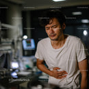 Man Experiencing Abdominal Pain in Healthcare Setting