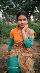 Young Woman in Bright Saree Sitting Outdoors among Greenery