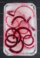 Red radish slices frozen in clear ice block