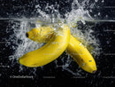 Fresh Yellow Bananas Splashing into Water with Dynamic Motion