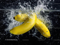 Fresh Yellow Bananas Splashing into Water with Dynamic Motion