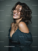 Smiling Woman with Wavy Hair Wearing Blue Top in Studio Shot