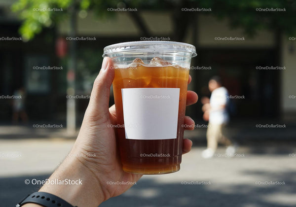 Hand Holding Iced Coffee Outdoors on Sunny Day JPG Mockup Image