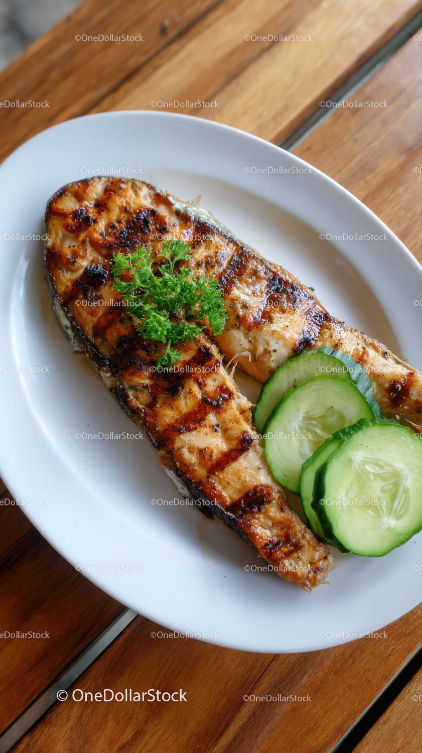 Fresh Grilled Salmon with Cucumber Slices on White Plate