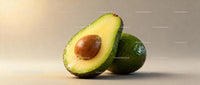 Fresh ripe avocado with a seed on neutral background