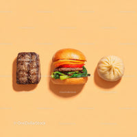 Gourmet Burger with Lettuce and Tomato Next to Grilled Steak and Dumpling