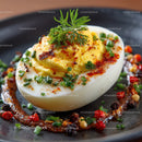 Deviled Egg with Chives and Spices on Black Plate