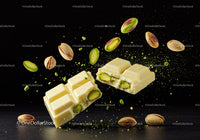 Broken white chocolate bar with pistachios in midair