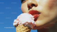 Close-Up of Woman Licking Strawberry Ice Cream Cone in Summer