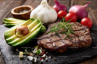 Juicy Grilled Steak with Fresh Avocado and Garlic on Rustic Board