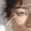 Close-up of Woman Applying Soft Pink Eyeshadow with Makeup Brush
