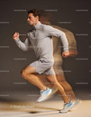 Dynamic young male athlete sprinting fast indoors