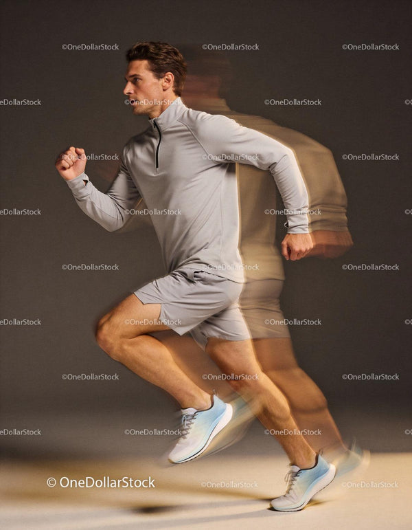Dynamic young male athlete sprinting fast indoors