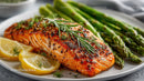 Grilled Salmon with Asparagus and Lemon Slices on a White Plate