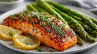 Grilled Salmon with Asparagus and Lemon Slices on a White Plate