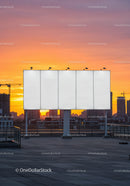 Empty Billboard on Rooftop with City Skyline at Sunset