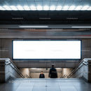 Blurred commuters in modern subway station stairway
