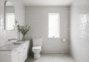 Bright White Tiled Bathroom with Modern Fixtures and Natural Light
