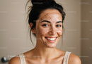 Woman with Freckles Applying Facial Scrub for Skincare Routine