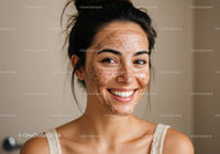Woman with Freckles Applying Facial Scrub for Skincare Routine