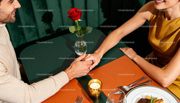 Couple holding hands on a romantic dinner date