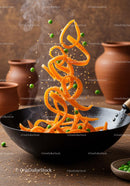 Steaming stir-fry with carrots and green peas in wok