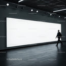 Man Walking Past Large Illuminated Advertising Display