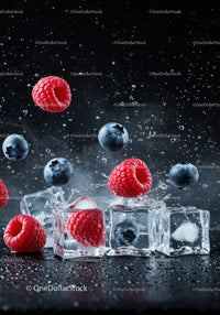 Fresh raspberries and blueberries with ice cubes splash