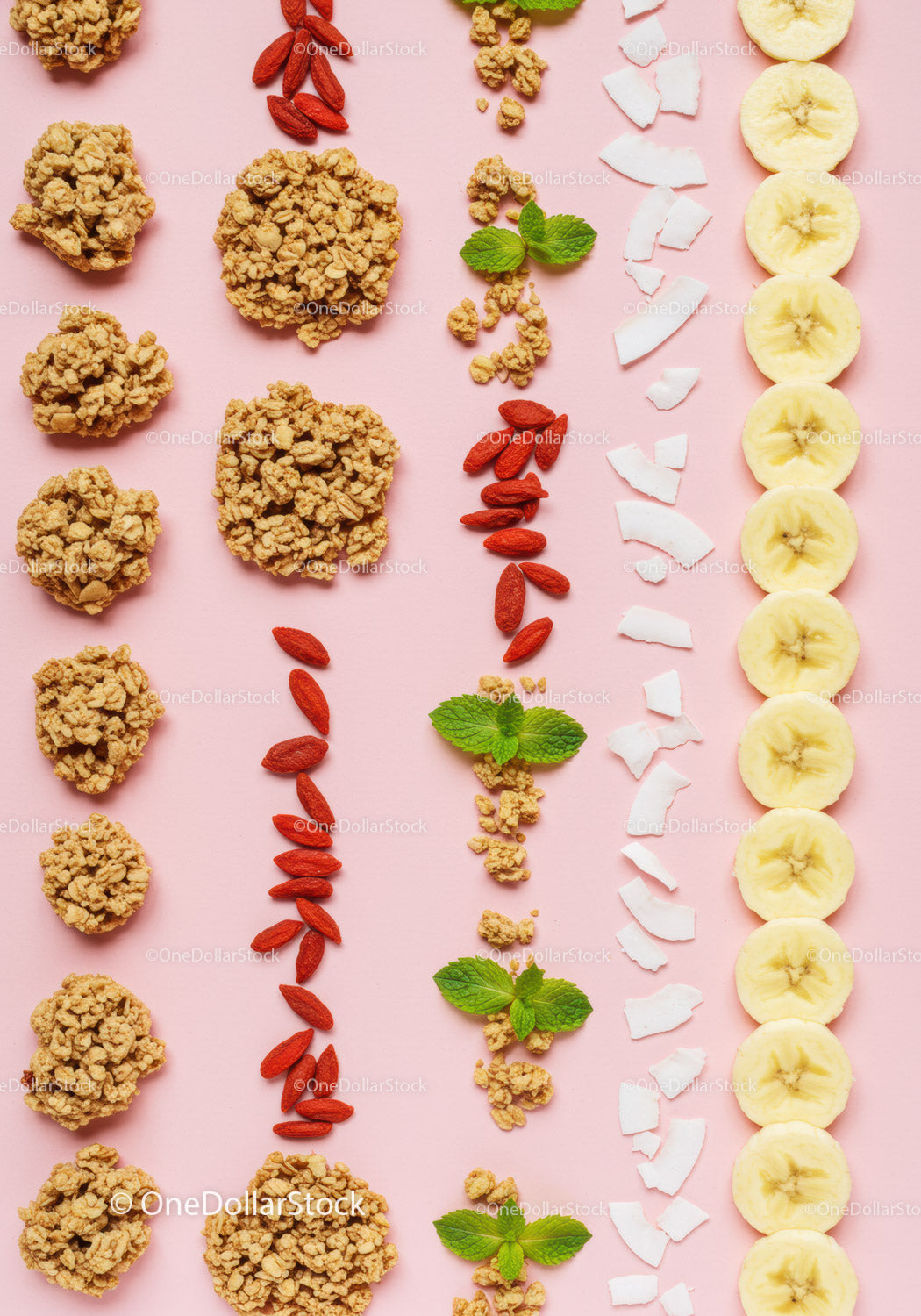 Healthy breakfast ingredients arranged on pink background