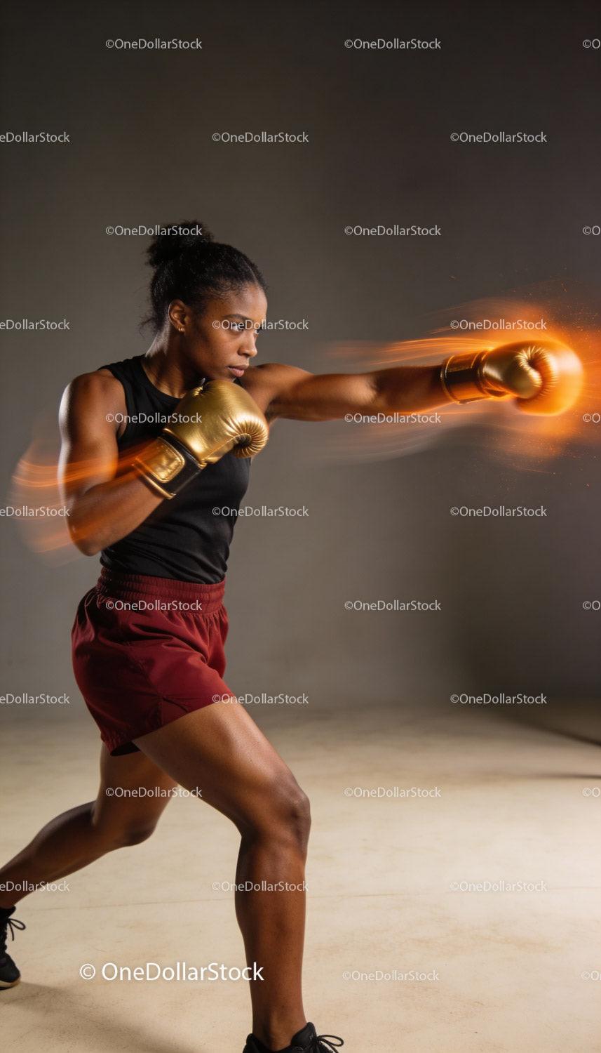 Focused female boxer delivering powerful punch