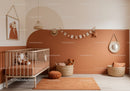 Warm Peach and Beige Nursery with Woven Baskets and Wall Art