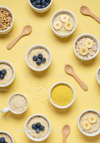 Assorted Breakfast Bowls with Fruit and Grains on Yellow