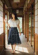 Young Woman in White Blouse and Navy Skirt Standing Inside Traditional Japanese Room