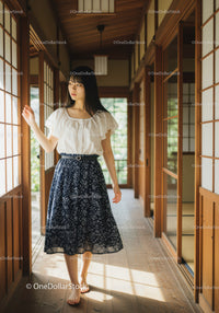 Young Woman in White Blouse and Navy Skirt Standing Inside Traditional Japanese Room