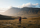 Scenic Mountain Range with Hiker in Grassy Valley Landscape