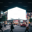 Busy Japanese city intersection at night with illuminated billboard