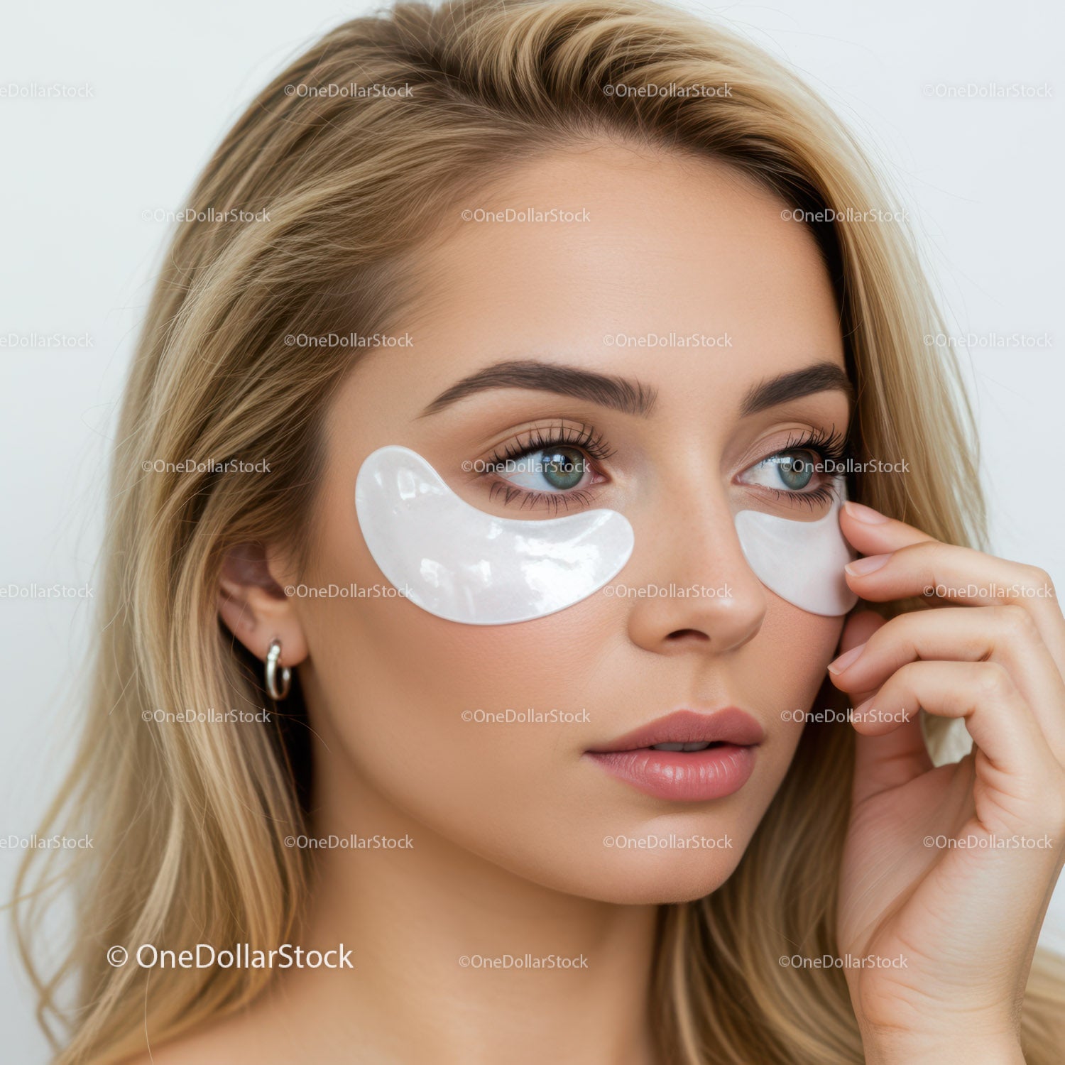 Young Woman Applying Eye Patches for Skincare Treatment