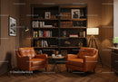 Cozy reading nook with leather chairs and wooden shelves