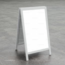 Blank white sandwich board sign on gray pavement
