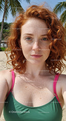 Freckled Woman Enjoying a Sunny Beach Day