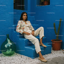 Elegant Woman in Traditional Attire Against a Vibrant Blue Wall