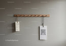 Wooden Coat Rack with Hanging Items on Gray Wall Interior