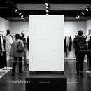 Blank vertical display board in modern fashion store interior