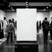 Blank vertical display board in modern fashion store interior